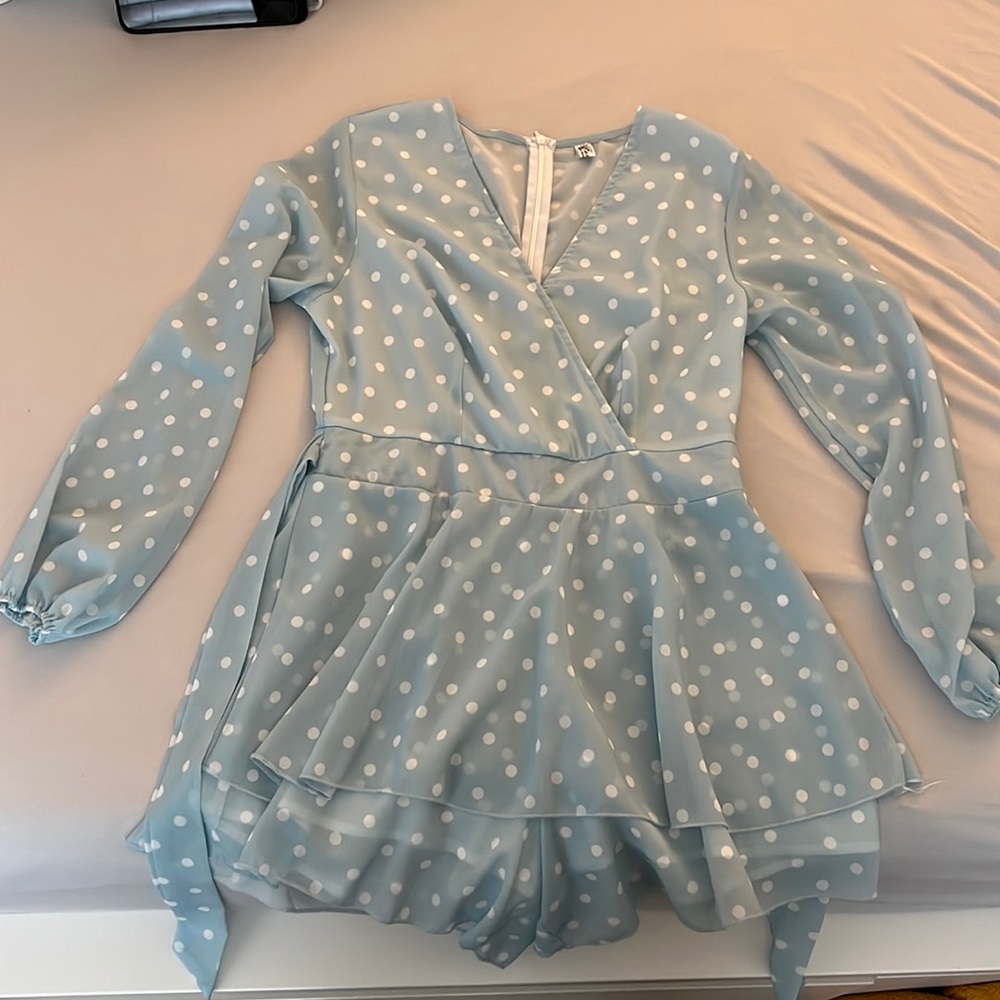 Baby blue polka dotted romper with ruffles. Size M, true to size